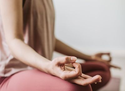 Close-up of hands in a meditative mudra position.