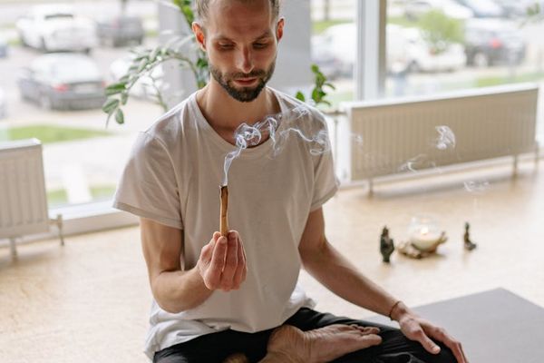 Person engaged in a mindful yoga practice in a minimalist space.